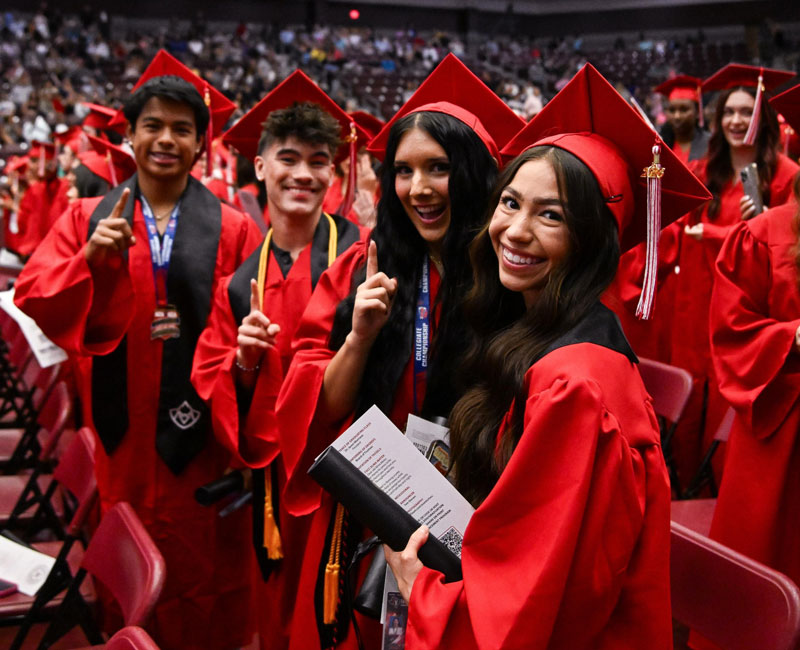 TVCC graduates posing for photo in their caps and gowns. 